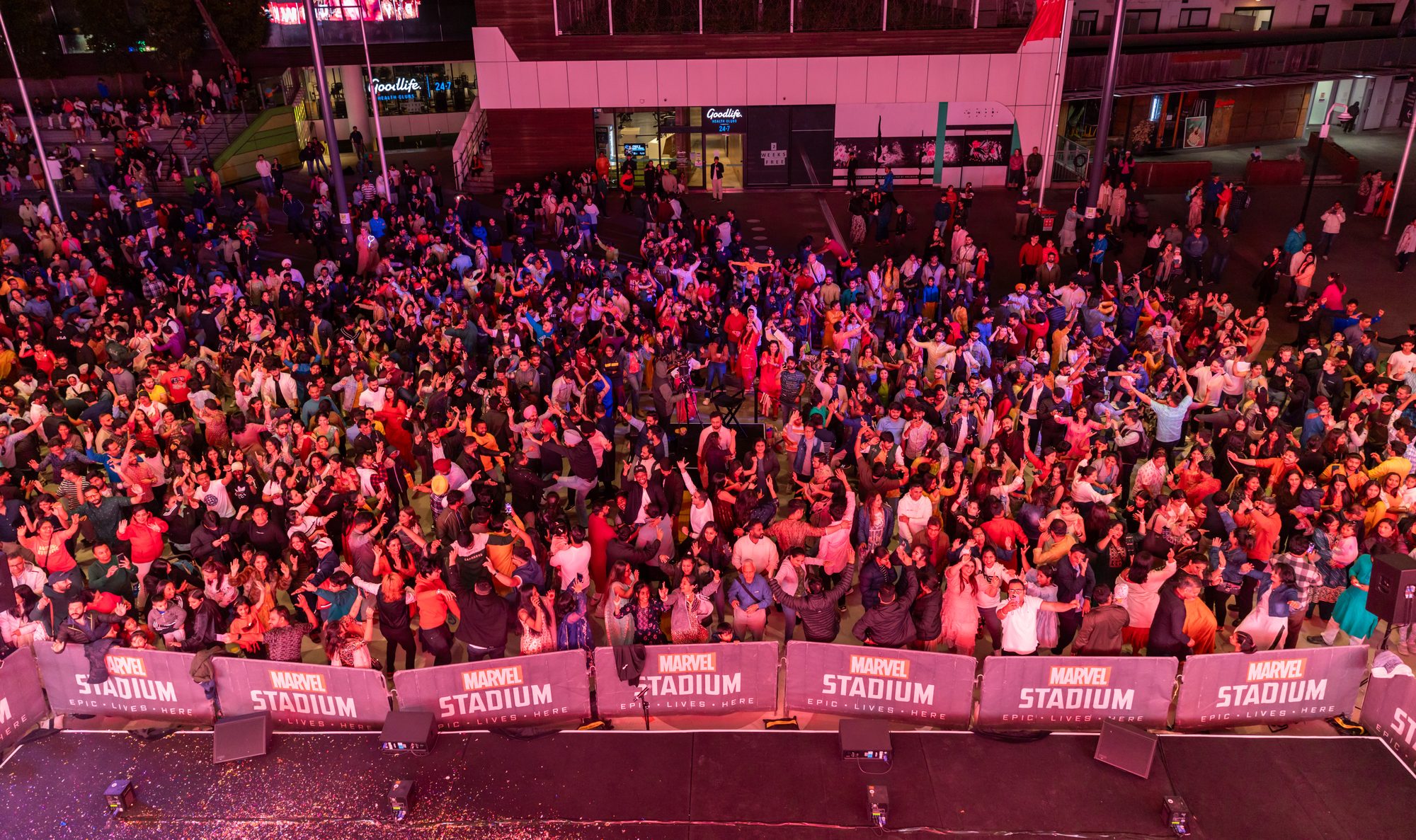 A crowd dancing in Marvel Stadium Square, seen from the Melbourne Diwali stage